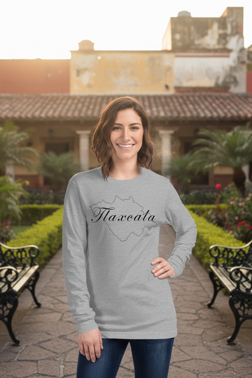 A woman wearing a long sleeve crew neck t-shirt in athletic heather color with the text 'Tlaxcala' on it.