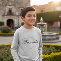 A child wearing a long sleeve gray T-shirt with the text 'Tlaxcala' printed on the front.