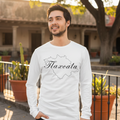 A person wearing a white long sleeve T-shirt with the text 'Tlaxcala' on it, standing against an athletic heather background.