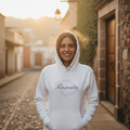 A white hoodie with 'Tlaxcala' text on the front, featuring a hood and a front pouch pocket.
