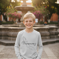 A child wearing a long sleeve gray t-shirt with the text 'Veracruz' printed on the front.