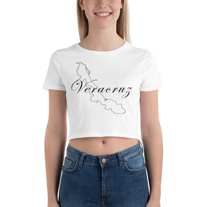 A woman wearing a white short-sleeved crop t-shirt with 'Veracruz' text printed on the front, paired with blue jeans.