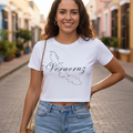A woman wearing a white short-sleeved crop t-shirt with 'Veracruz' text printed on the front, paired with blue jeans.