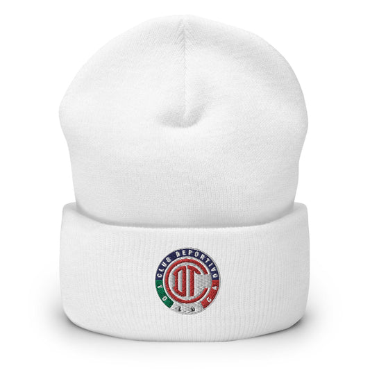 A white cuffed beanie with a Club Toluca logo on the front side.
