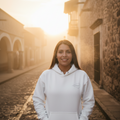 A white unisex hoodie with a front pouch pocket and a hood, featuring a small graphic on the front.