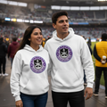 A man and a woman standing in a stadium, both wearing matching white Mazatlan hoodies with a purple and black circular logo printed on the chest.