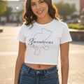 A woman wearing a white short-sleeved crop t-shirt with the text 'Zacatecas' printed on the front, paired with blue denim jeans.