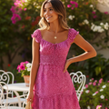 A red mini dress with ruffle sleeves and a sweetheart neckline, featuring a floral print and a ruffle hem.