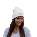 A person wearing a white embroidered beanie hat with the text 'Yucatan' on it.