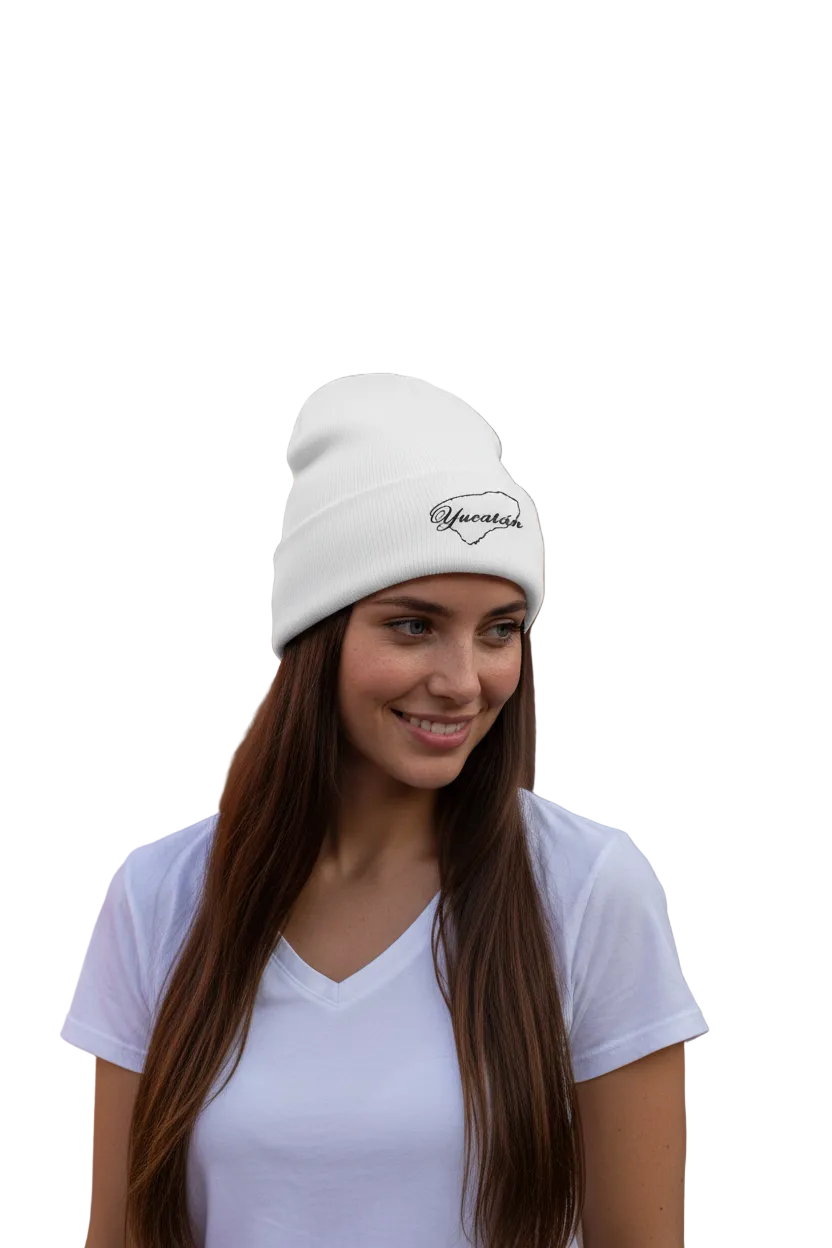 A person wearing a white embroidered beanie hat with the text 'Yucatan' on it.