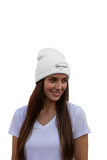 A person wearing a white embroidered beanie hat with the text 'Yucatan' on it.