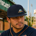 A Mexican model wearing the Leones de Yucatan snapback hat in a realistic outdoor lifestyle setting, with the front design clearly visible. The Leones de Yucatan snapback hat is shown naturally.