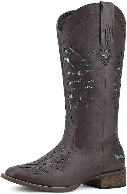 Black cowboy boots with square toe and ornate stitched floral panels, chunky heel.